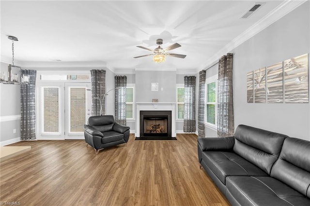 1604 Sunny Hill Way, Colfax, NC 27235 - living area with crown molding, wood finished floors, baseboards, a fireplace with flush hearth, and ceiling fan