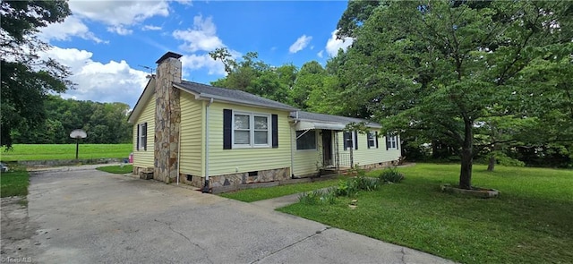 3613 Mcconnell Rd, Greensboro, NC 27405 - view of front of home featuring a front lawn, concrete driveway, and a chimney
