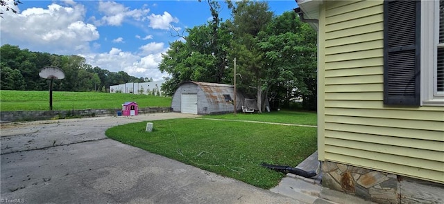 3613 Mcconnell Rd, Greensboro, NC 27405 - view of grassy yard with a garage, driveway, and a storage unit