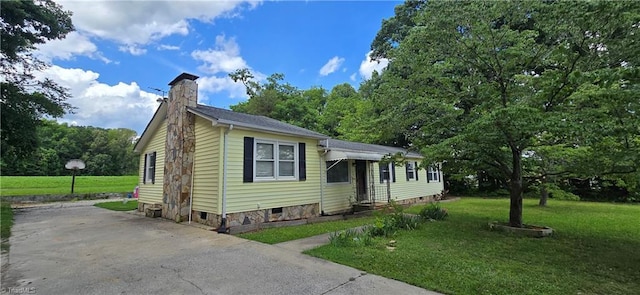 3613 Mcconnell Rd, Greensboro, NC 27405 - manufactured / mobile home with a chimney, a front lawn, and concrete driveway