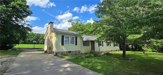 3613 Mcconnell Rd, Greensboro, NC 27405 - view of front of home with a chimney, a front lawn, and driveway