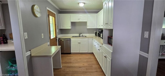 3613 Mcconnell Rd, Greensboro, NC 27405 - kitchen featuring stainless steel dishwasher, white cabinetry, light wood finished floors, light countertops, and crown molding