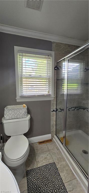 3613 Mcconnell Rd, Greensboro, NC 27405 - full bathroom with ornamental molding, plenty of natural light, and a shower stall