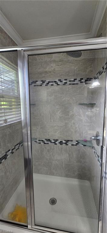 3613 Mcconnell Rd, Greensboro, NC 27405 - bathroom featuring crown molding and a shower stall