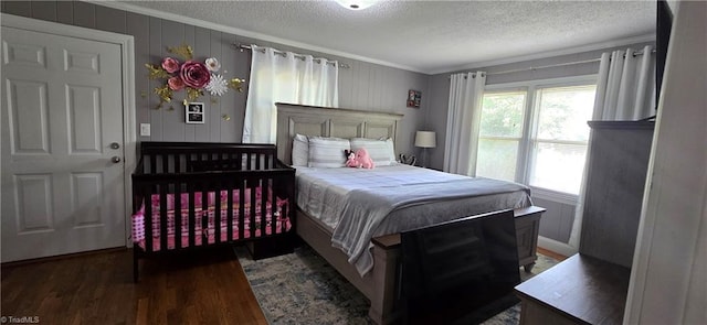 3613 Mcconnell Rd, Greensboro, NC 27405 - bedroom with ornamental molding, a textured ceiling, and wood finished floors