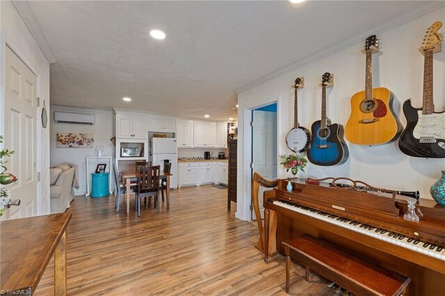interior space featuring crown molding, recessed lighting, a wall mounted air conditioner, and light wood-style floors