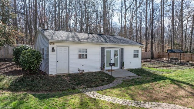 view of outbuilding with an outbuilding, a fenced backyard, and a vegetable garden