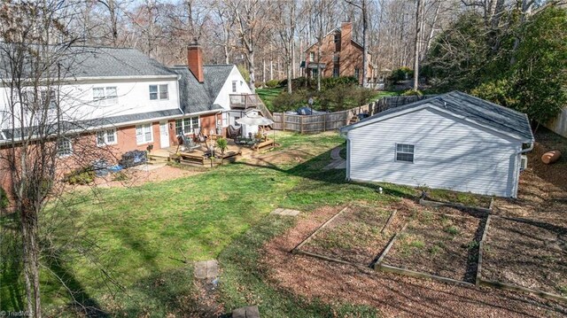 view of yard with fence and a wooden deck