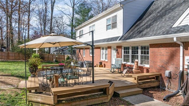 wooden deck featuring fence and outdoor dining area