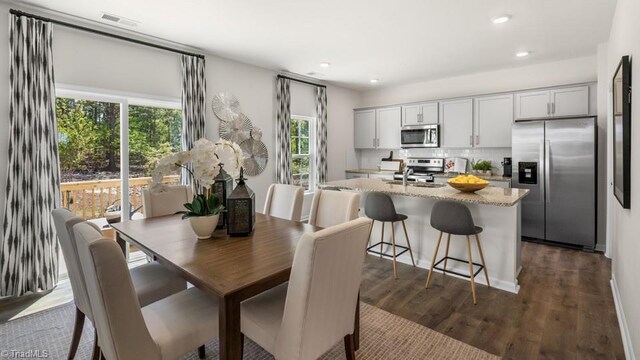 dining space with sink and dark wood-type flooring