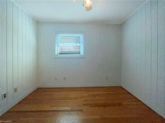 empty room featuring wood finished floors and a ceiling fan