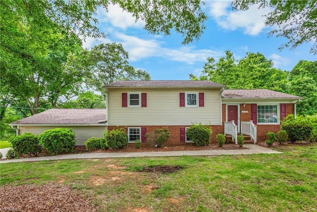 4642 Kings Gate Dr, Winston-Salem, NC 27101 - tri-level home featuring a front lawn and brick siding