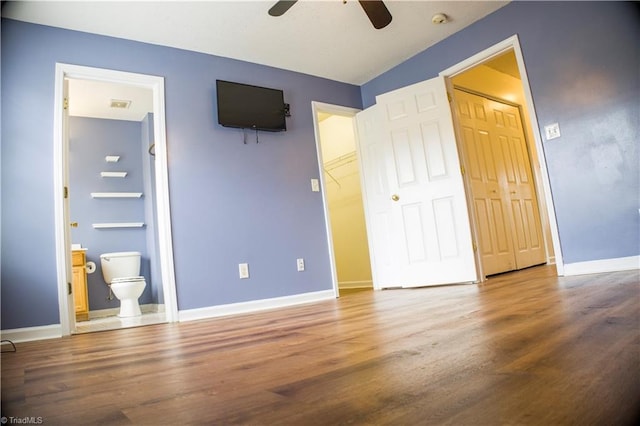 unfurnished bedroom with ensuite bath, ceiling fan, and hardwood / wood-style floors