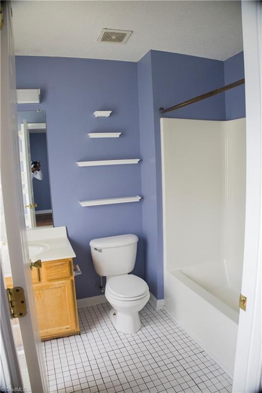 full bathroom with shower / bathing tub combination, vanity, tile patterned flooring, toilet, and a textured ceiling