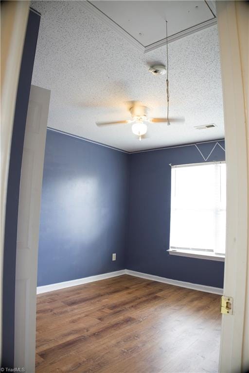 spare room with ceiling fan, a textured ceiling, and hardwood / wood-style flooring