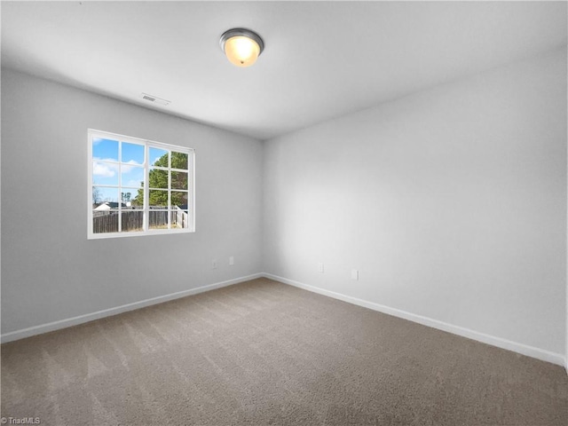 unfurnished room featuring carpet