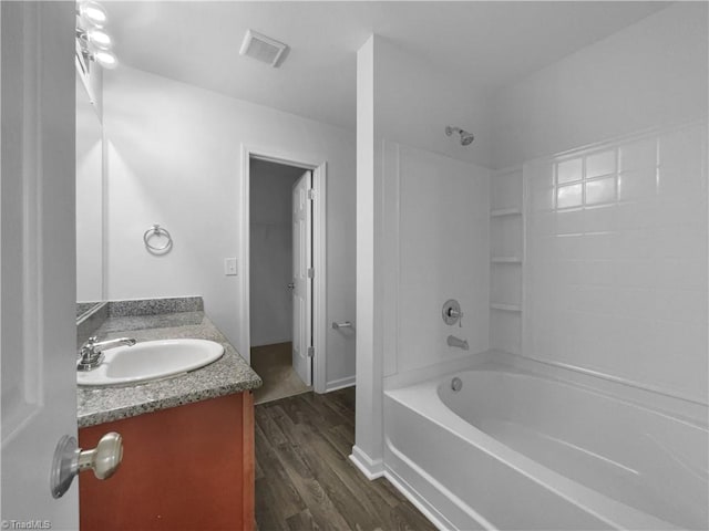 bathroom featuring vanity, hardwood / wood-style floors, and shower / bathtub combination