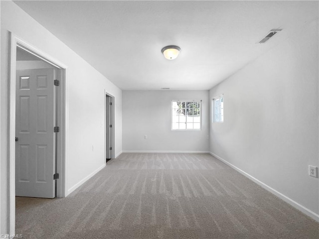 unfurnished room with light carpet