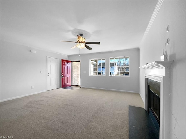 unfurnished living room featuring carpet floors, ornamental molding, and ceiling fan