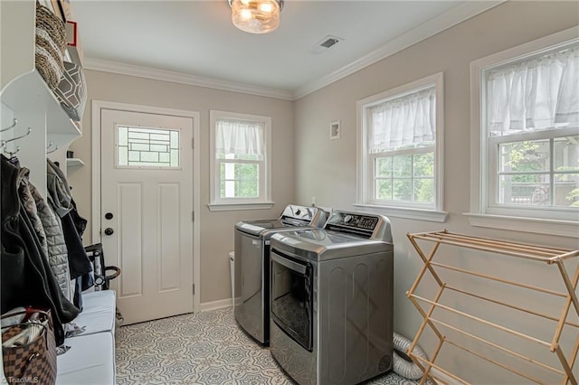 laundry room featuring laundry area, a healthy amount of sunlight, washer and dryer, and visible vents