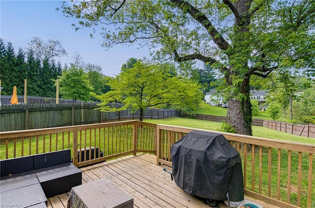 wooden deck with a yard, a fenced backyard, and grilling area