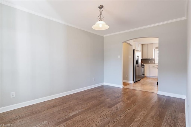 unfurnished room featuring hardwood / wood-style flooring and ornamental molding