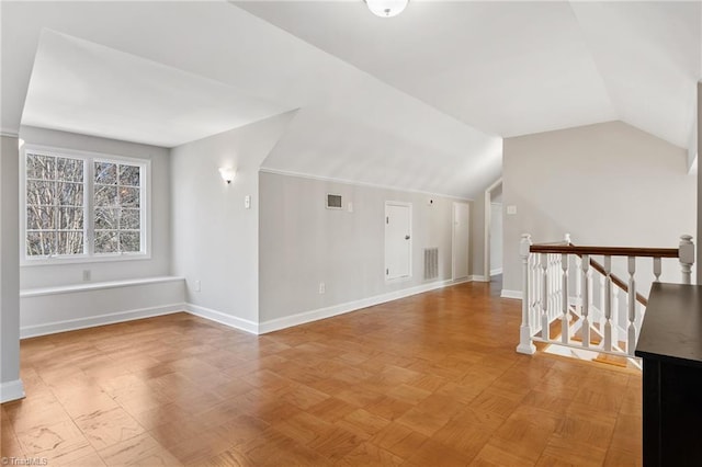 unfurnished living room with vaulted ceiling