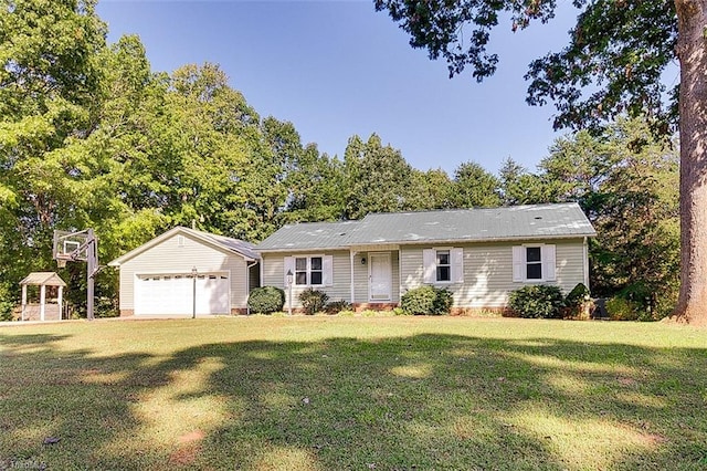 single story home featuring a front lawn, an outbuilding, and a garage