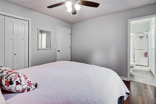 bedroom featuring ceiling fan, connected bathroom, and dark wood-type flooring