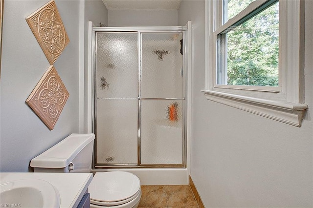 bathroom with vanity, toilet, tile patterned floors, and an enclosed shower