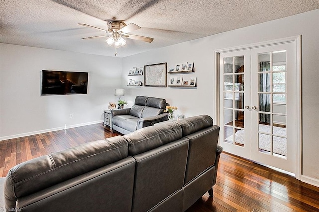 living room with a textured ceiling, dark hardwood / wood-style flooring, ceiling fan, and french doors