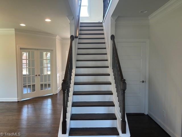 stairway with hardwood / wood-style floors, ornamental molding, and french doors