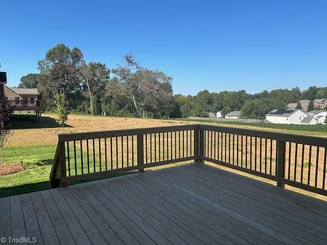 wooden terrace featuring a yard