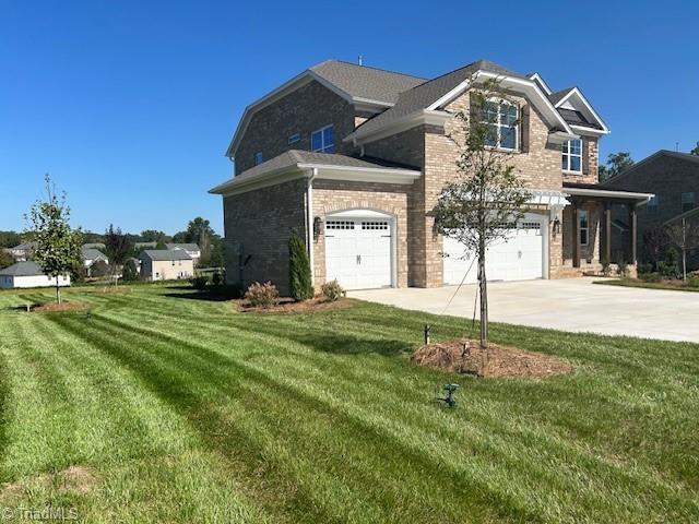 view of side of home with a garage and a lawn