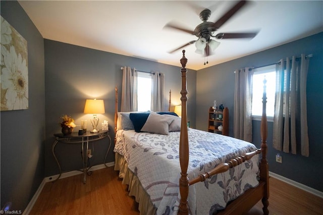 bedroom with ceiling fan and wood-type flooring