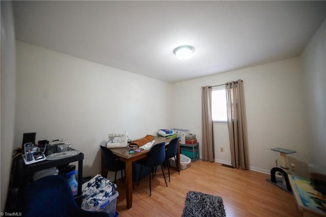 home office with light hardwood / wood-style floors