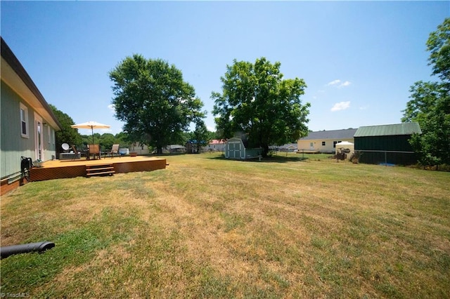 view of yard with a storage unit and a wooden deck