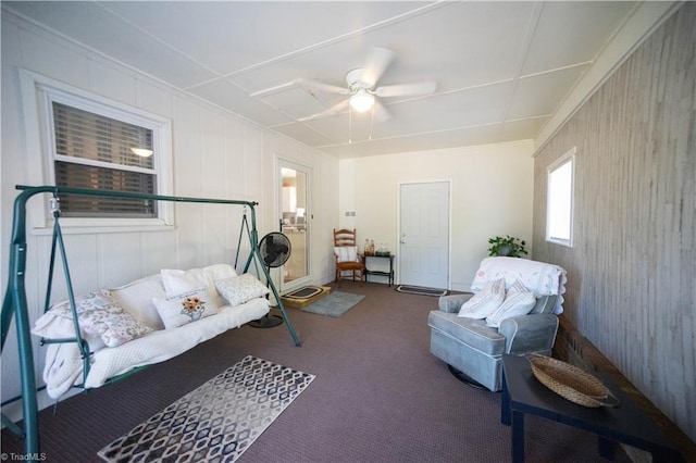 carpeted living room with ceiling fan