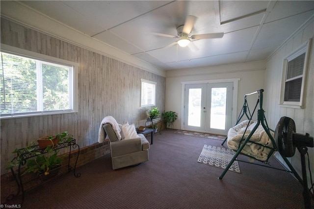 sitting room with carpet, french doors, and ceiling fan