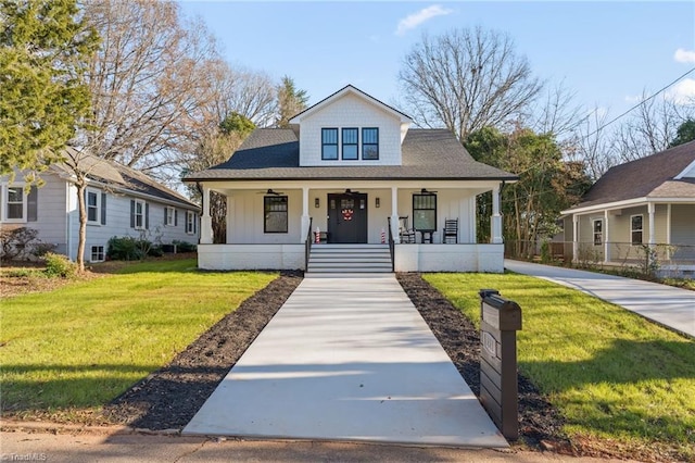 view of front of home with covered porch and a front lawn