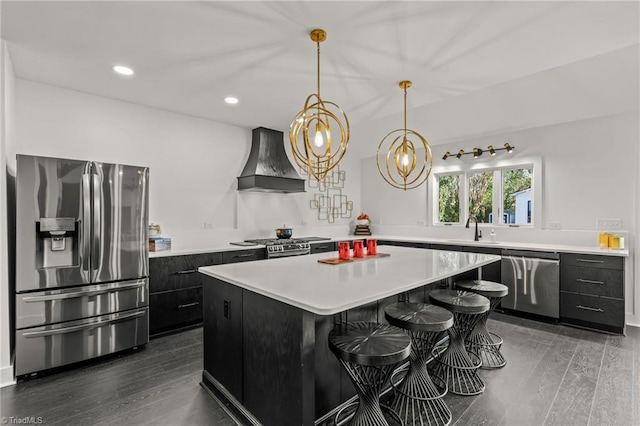 kitchen featuring a kitchen island, custom exhaust hood, dark hardwood / wood-style flooring, stainless steel appliances, and a breakfast bar