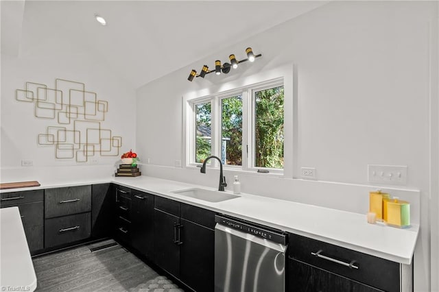 kitchen featuring vaulted ceiling, dishwasher, and sink