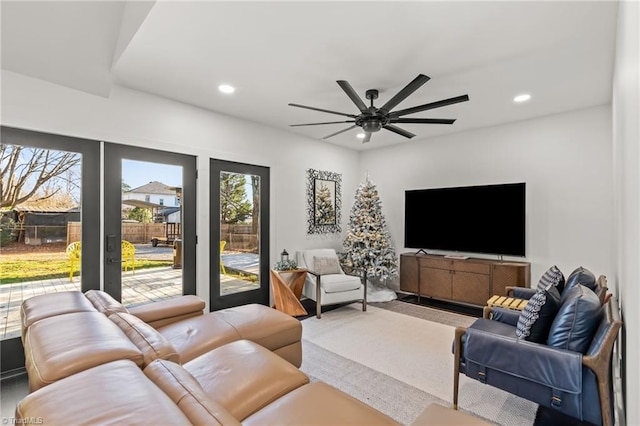 living room featuring ceiling fan and french doors