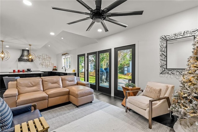 living room with vaulted ceiling, ceiling fan, light hardwood / wood-style flooring, and sink