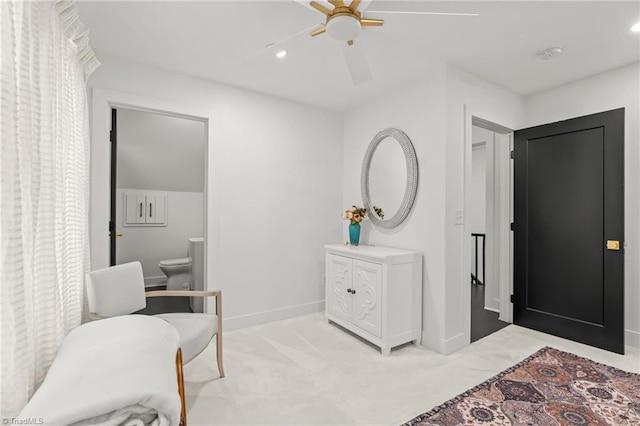 sitting room featuring ceiling fan and light colored carpet