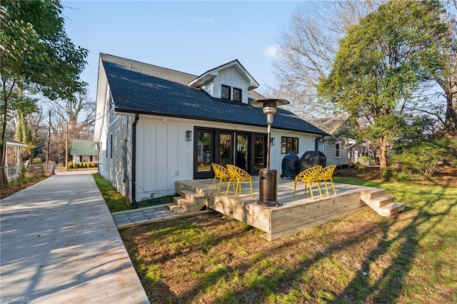 rear view of house featuring a yard