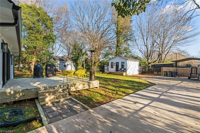 view of yard featuring an outbuilding, a patio area, and a deck