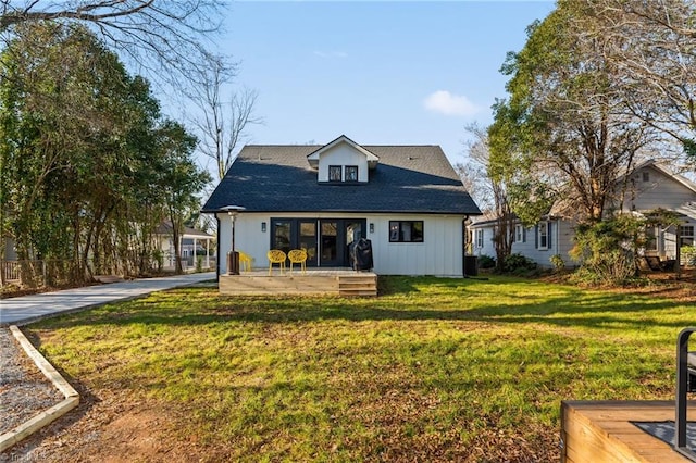 rear view of house with a yard