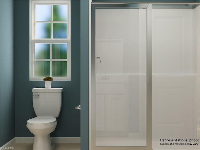 bathroom with toilet and baseboards