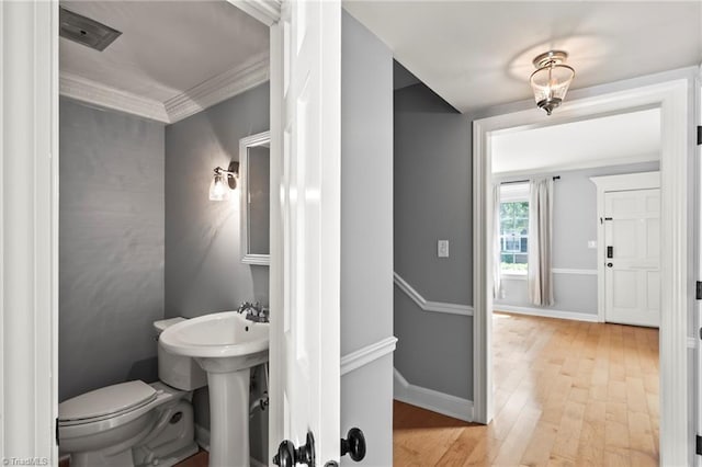 319 Hanover Arms Ct, Winston-Salem, NC 27104 - half bathroom featuring toilet, wood finished floors, baseboards, ornamental molding, and a sink